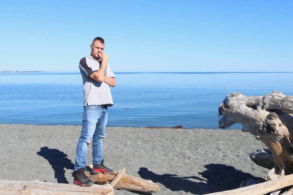 Joey Todd shares The Wealthy Loser with a supporter on the beach during an interview